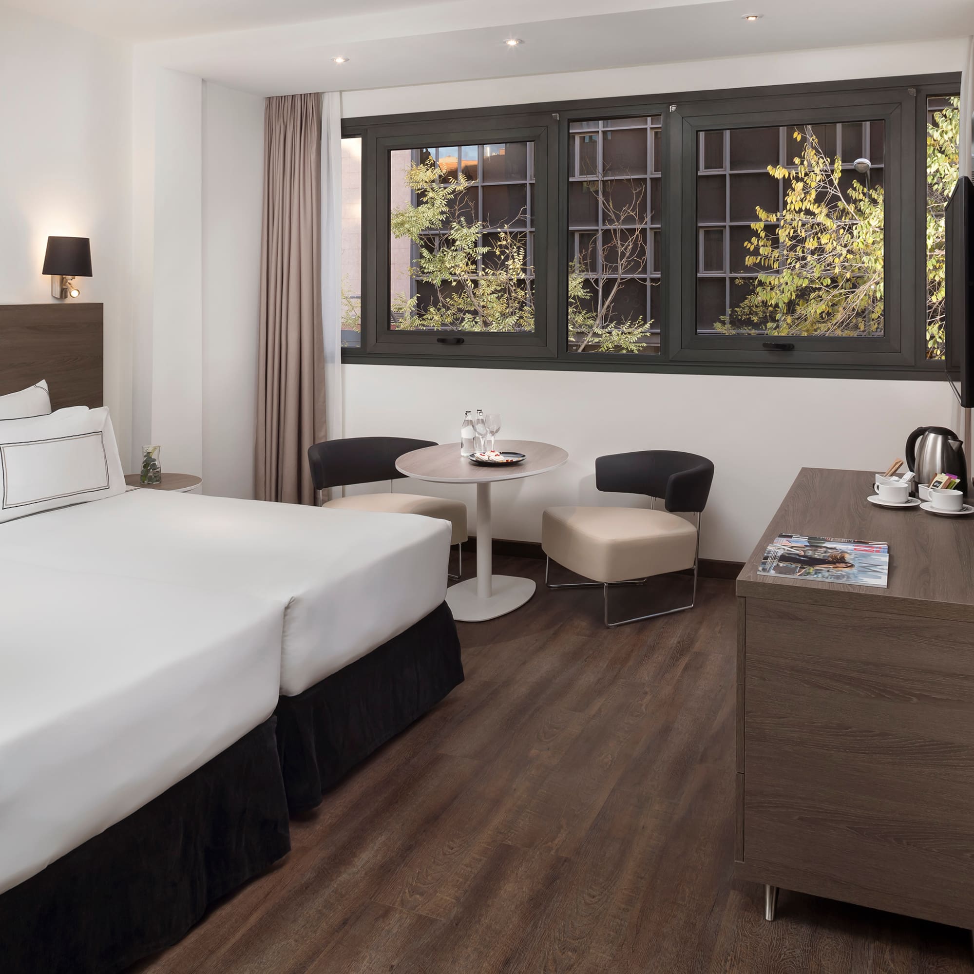 a room with two beds and a table