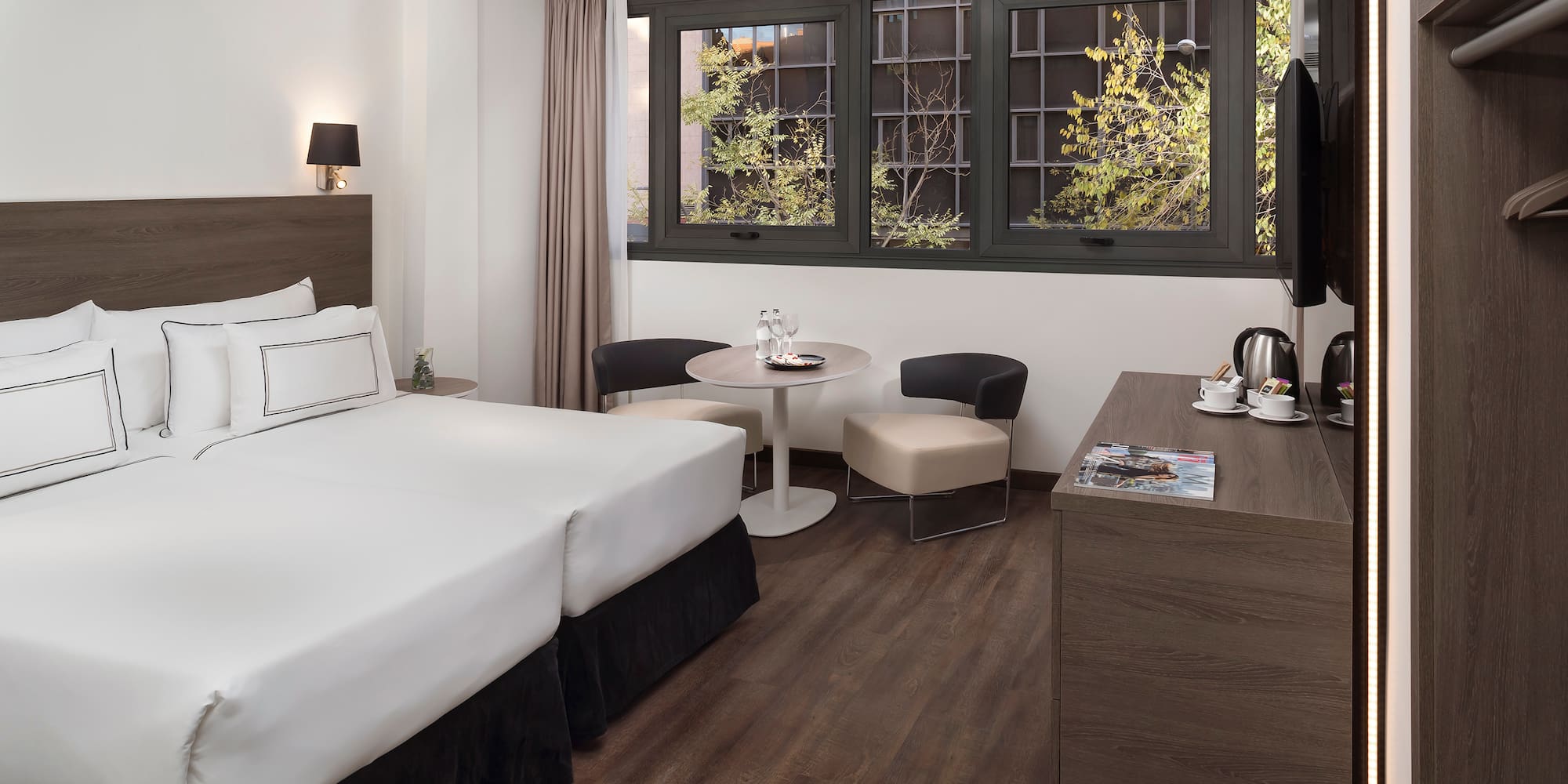 a room with two beds and a table