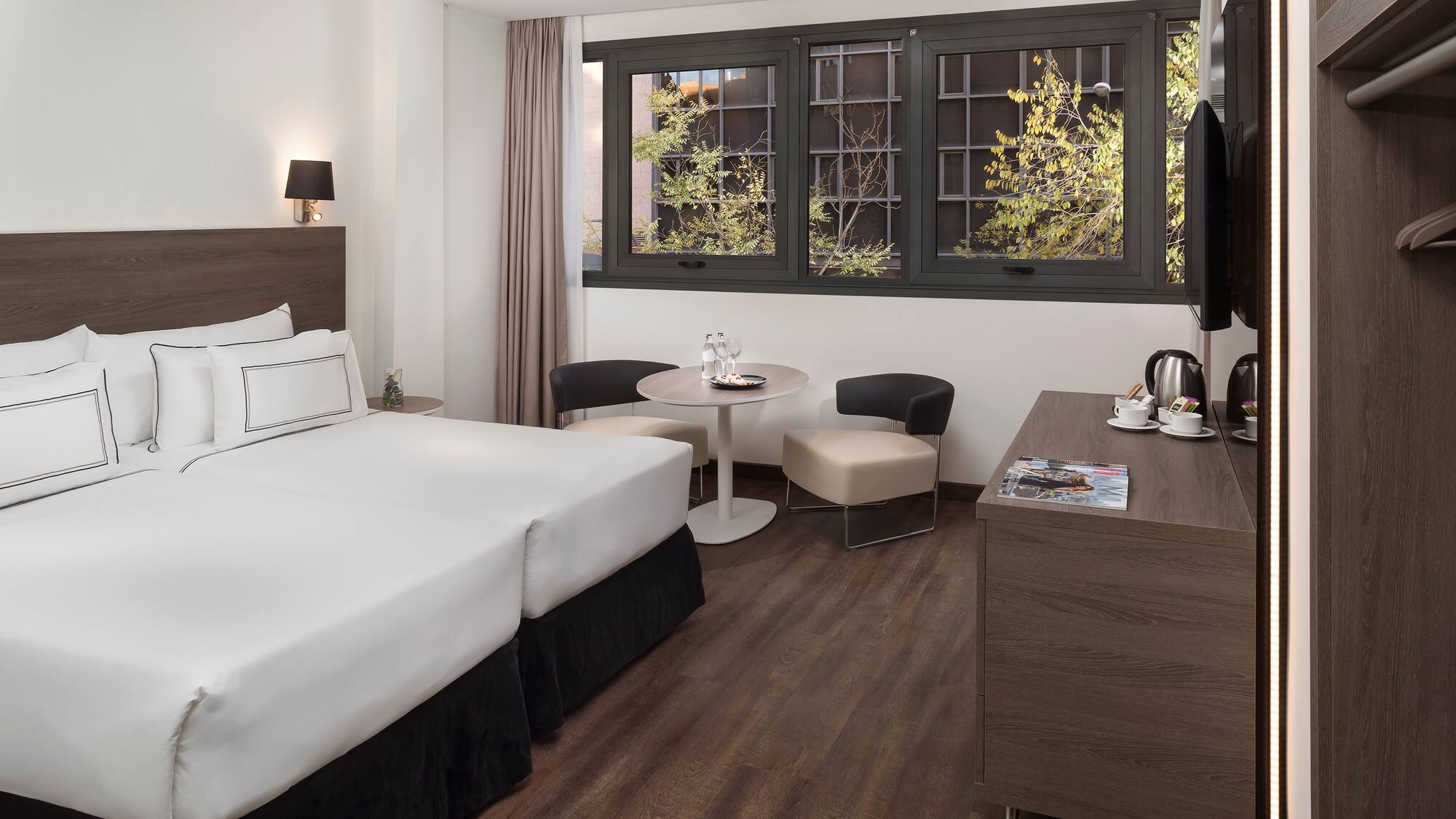 a room with two beds and a table