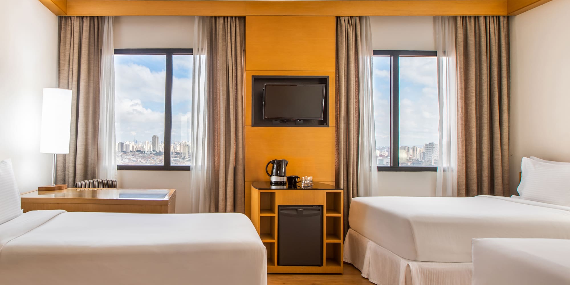 a room with two beds and a television