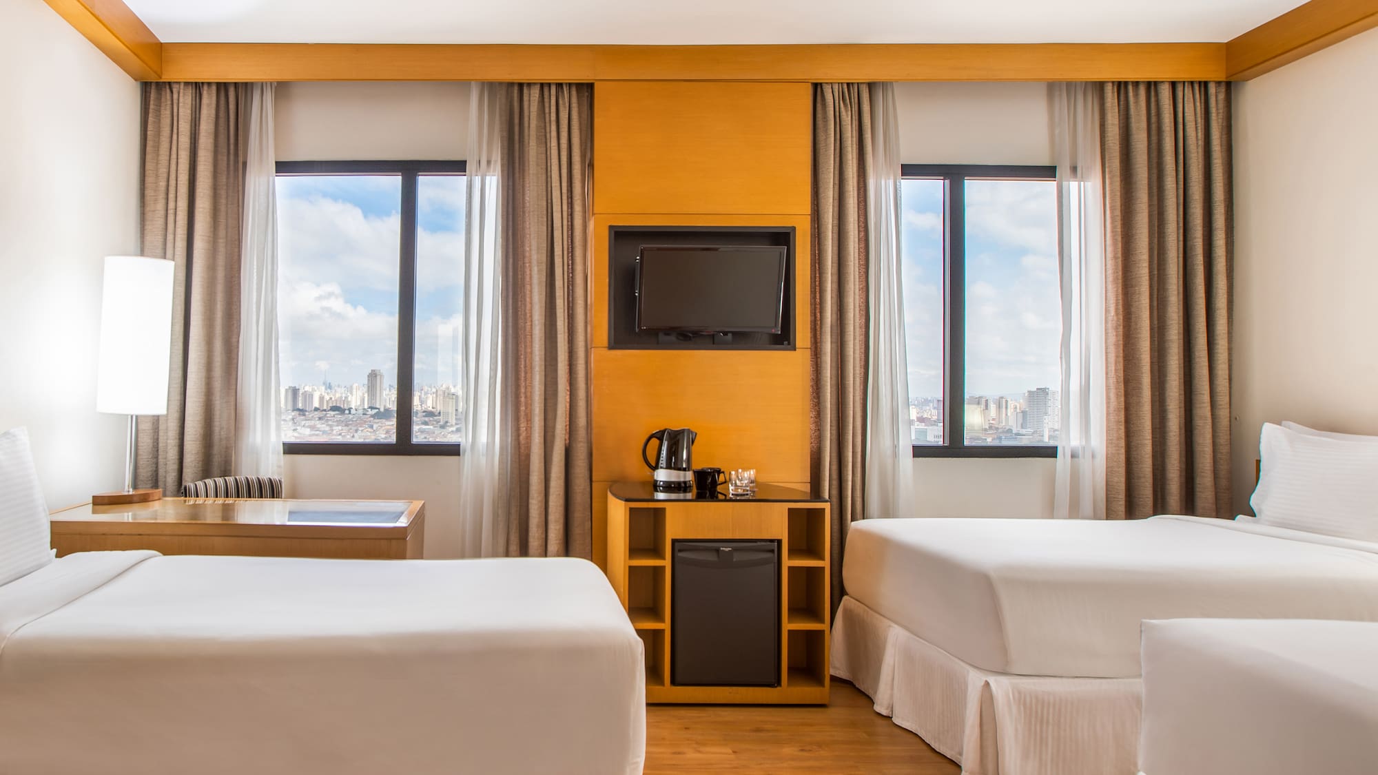 a room with two beds and a television