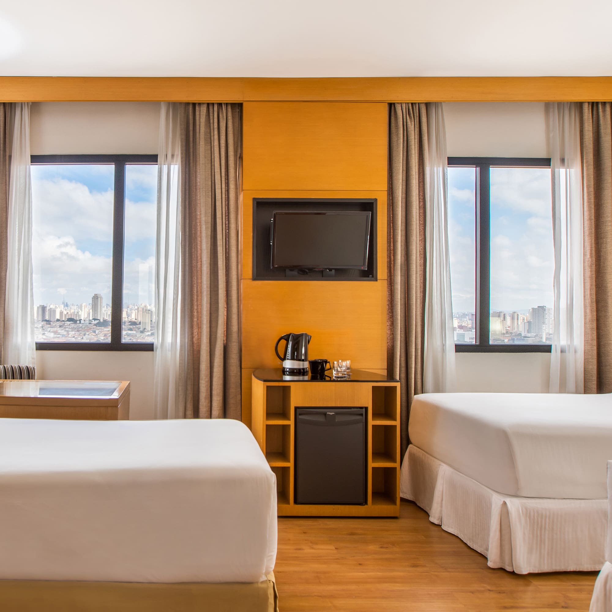 a room with two beds and a television