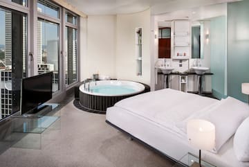a room with a large tub and a television