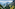 a mountain range with a river and a valley
