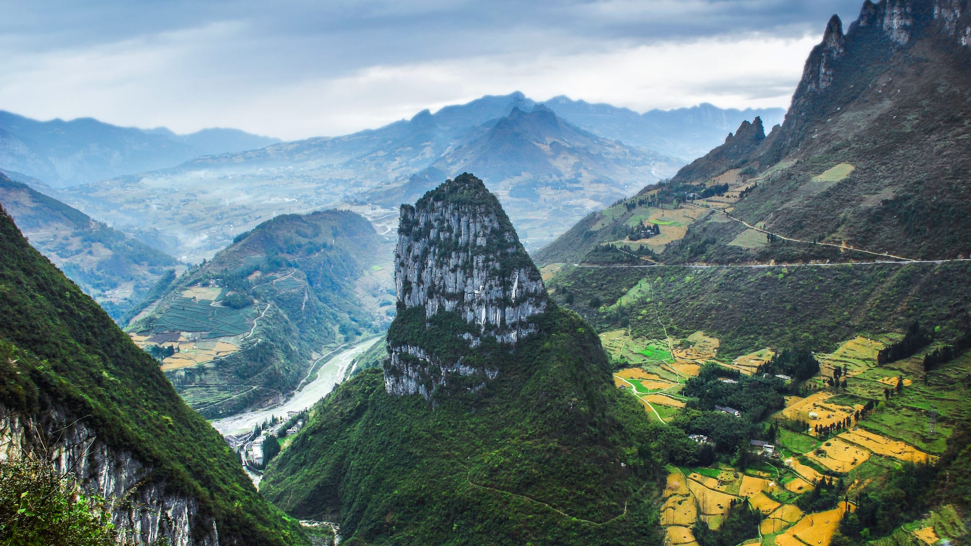a mountain range with a river and a valley