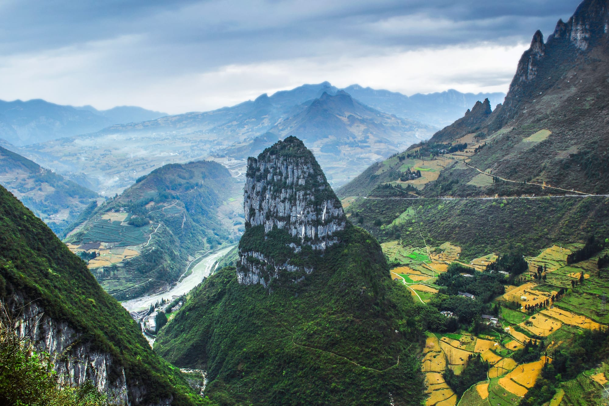 a mountain range with a river and a valley