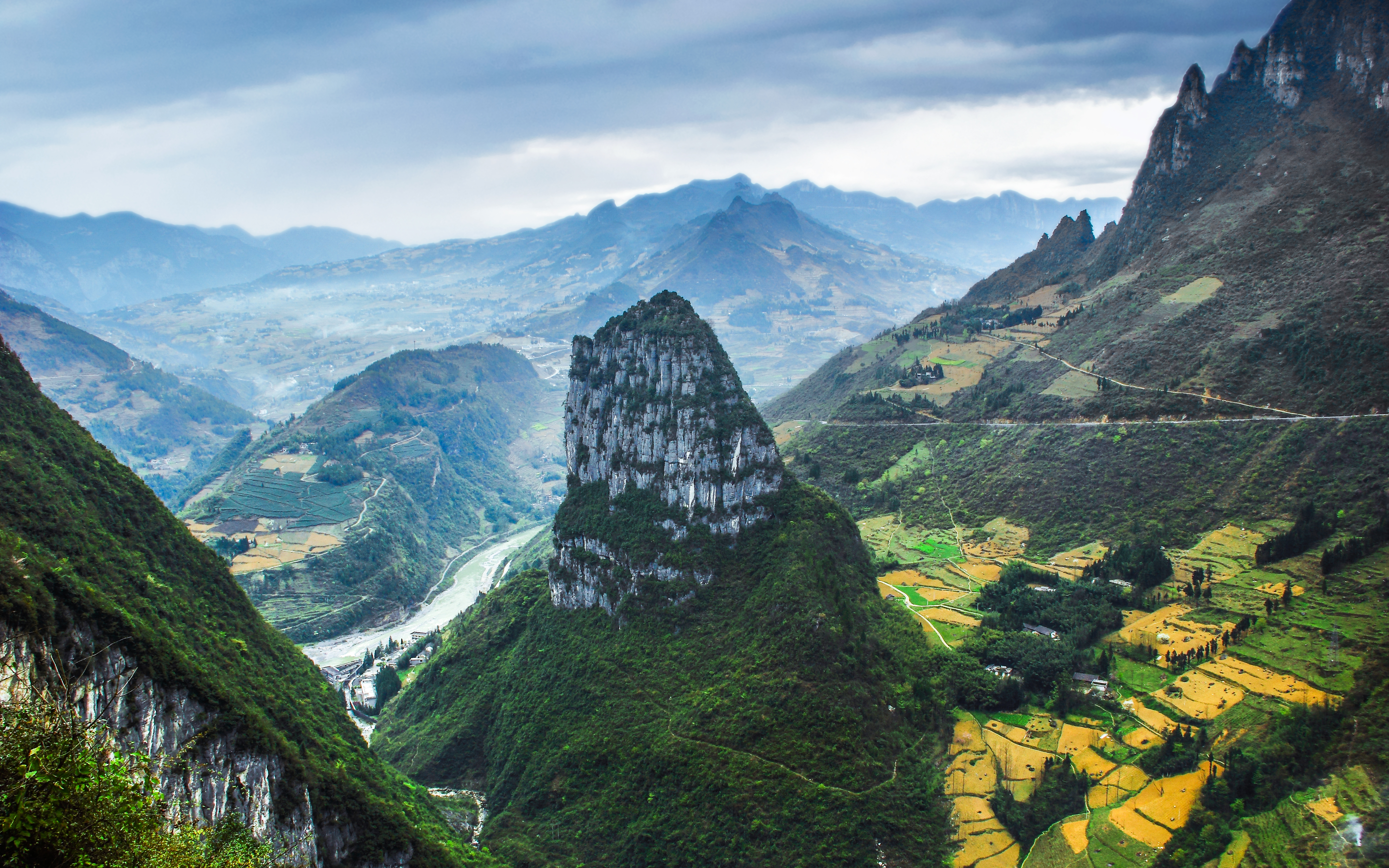 a mountain range with a river and a valley