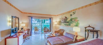 a room with a couch and chairs