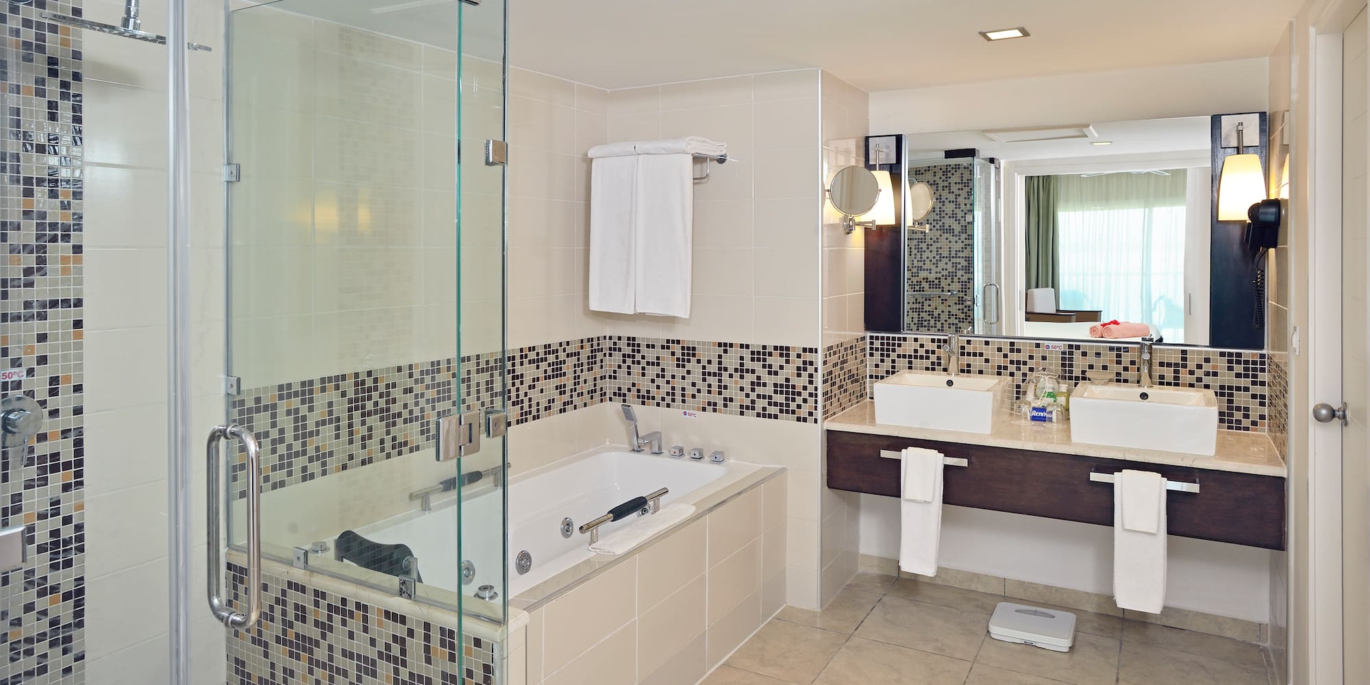 a bathroom with a glass shower and a bathtub