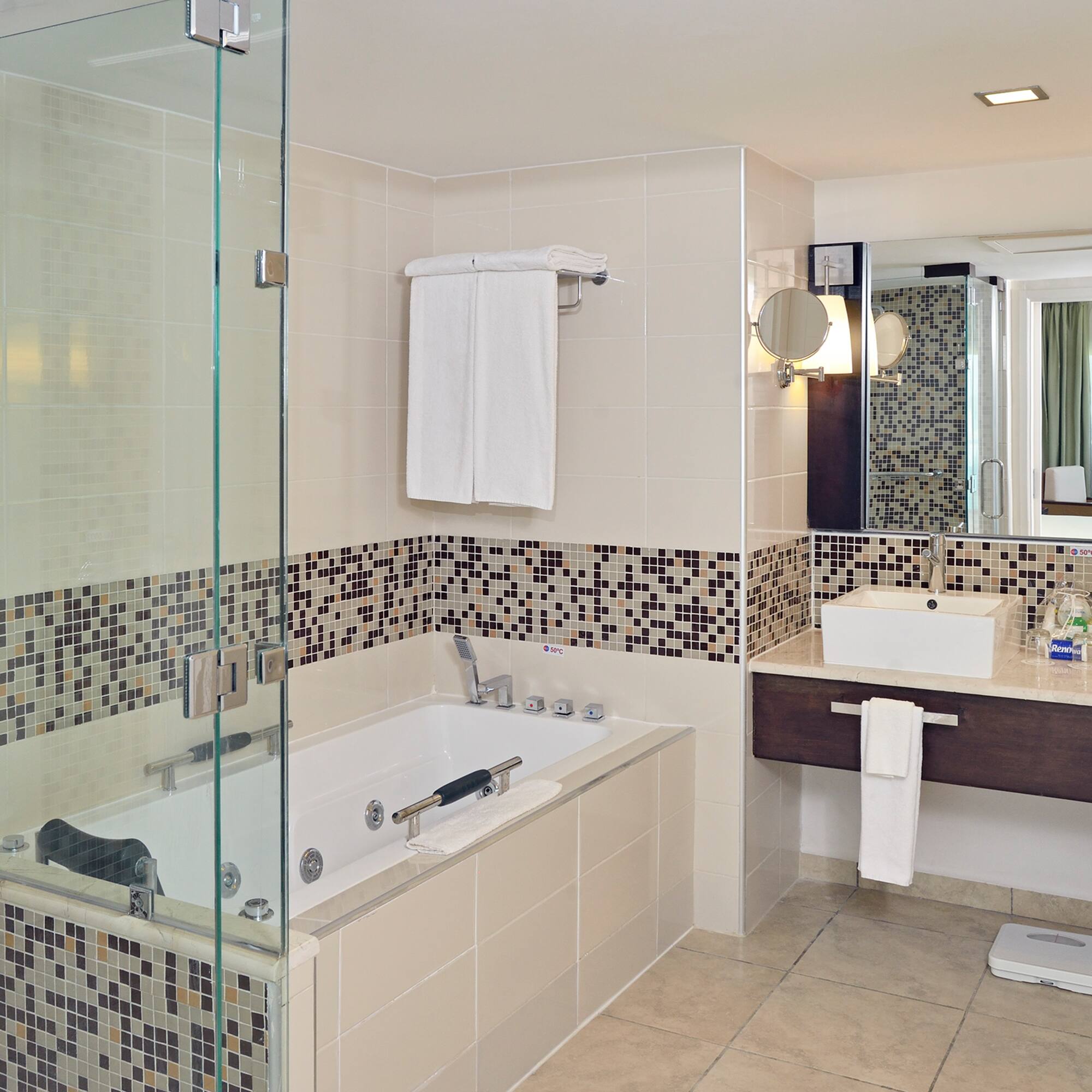 a bathroom with a glass shower and a bathtub