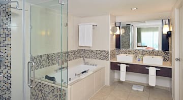 a bathroom with a glass shower and a bathtub