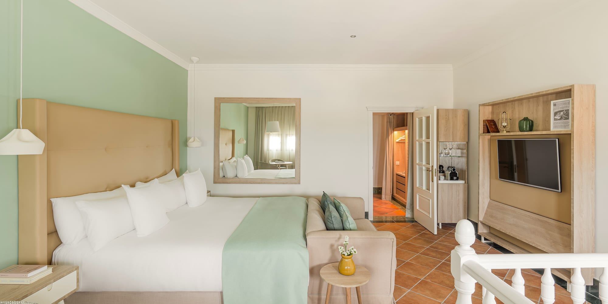 a bedroom with a bed and a television