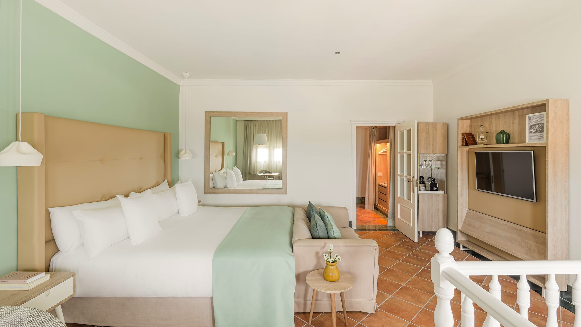 a bedroom with a bed and a television