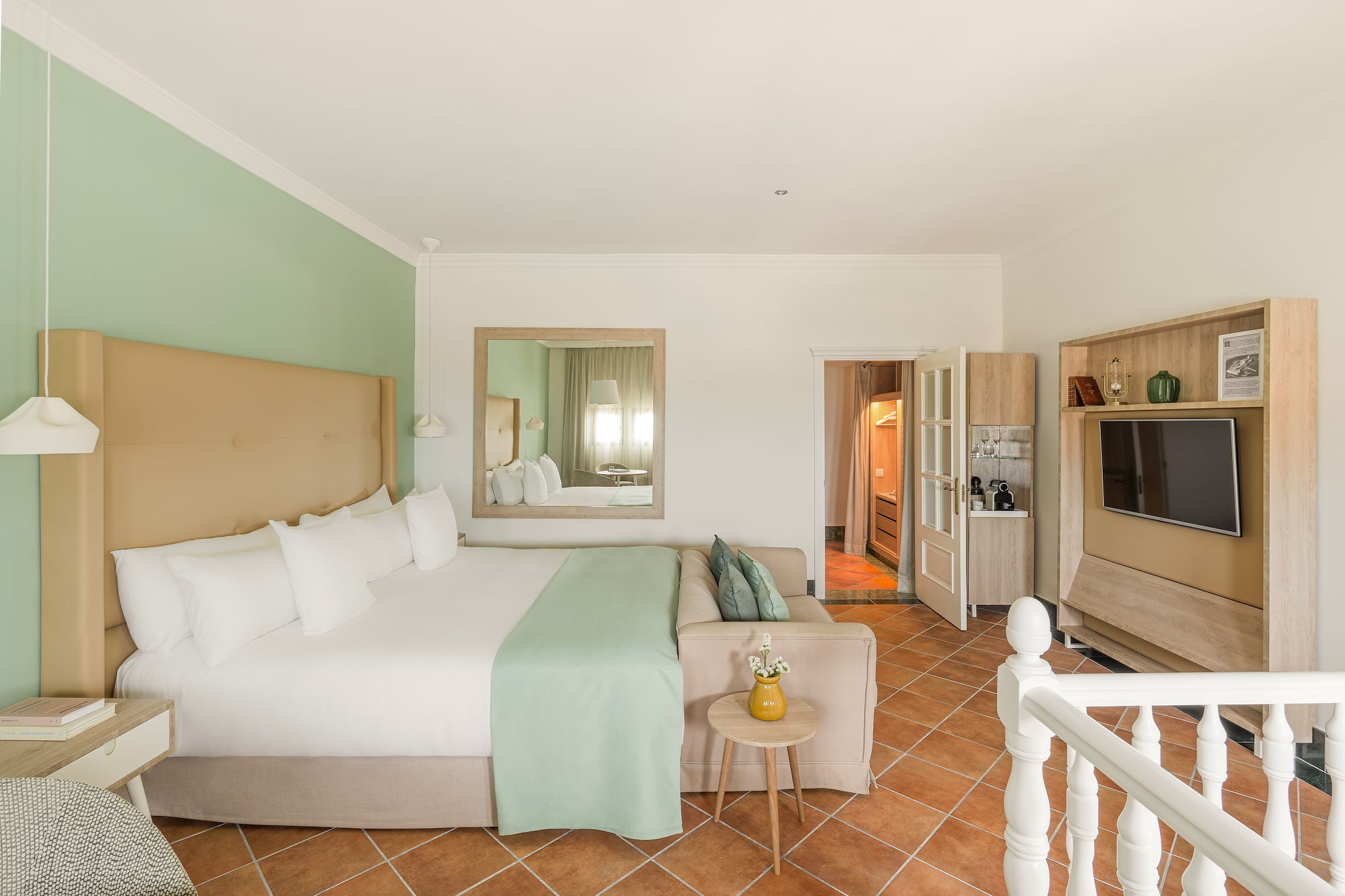 a bedroom with a bed and a television