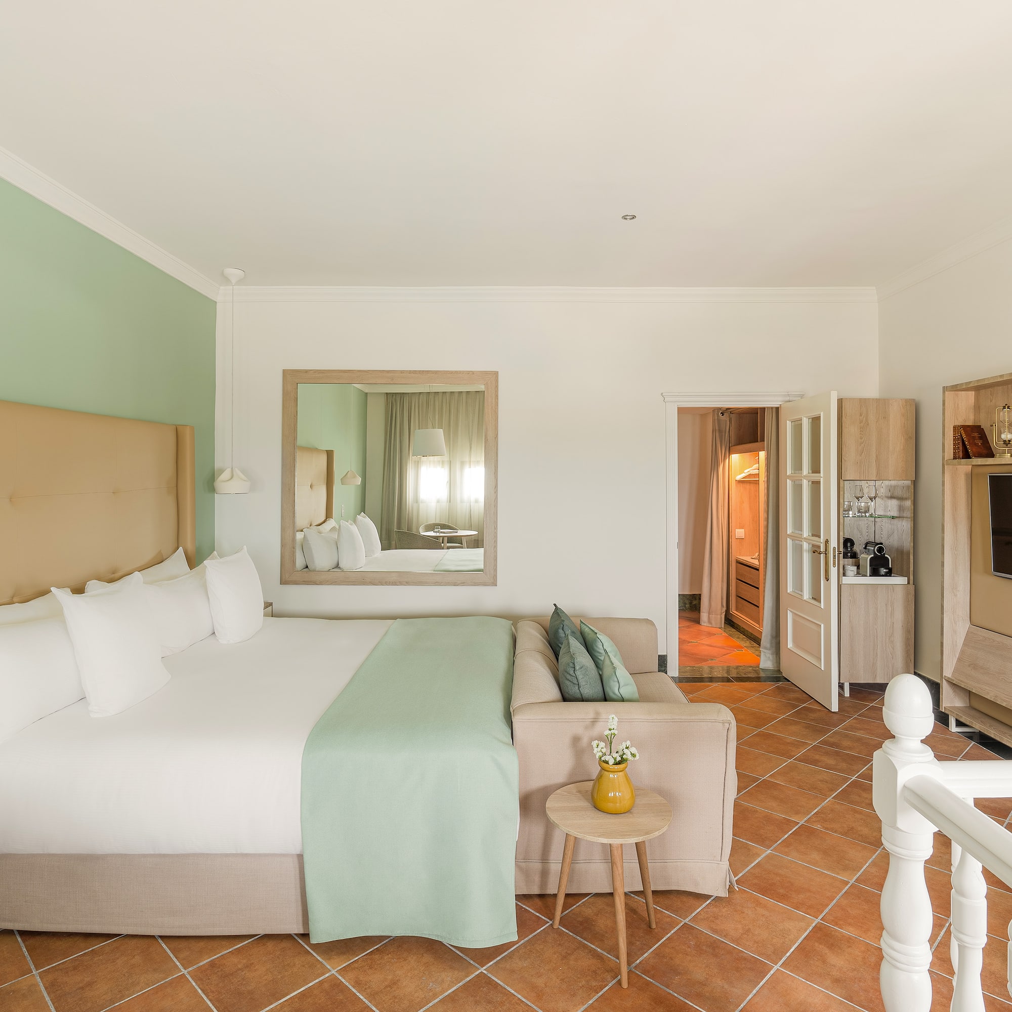 a bedroom with a bed and a television