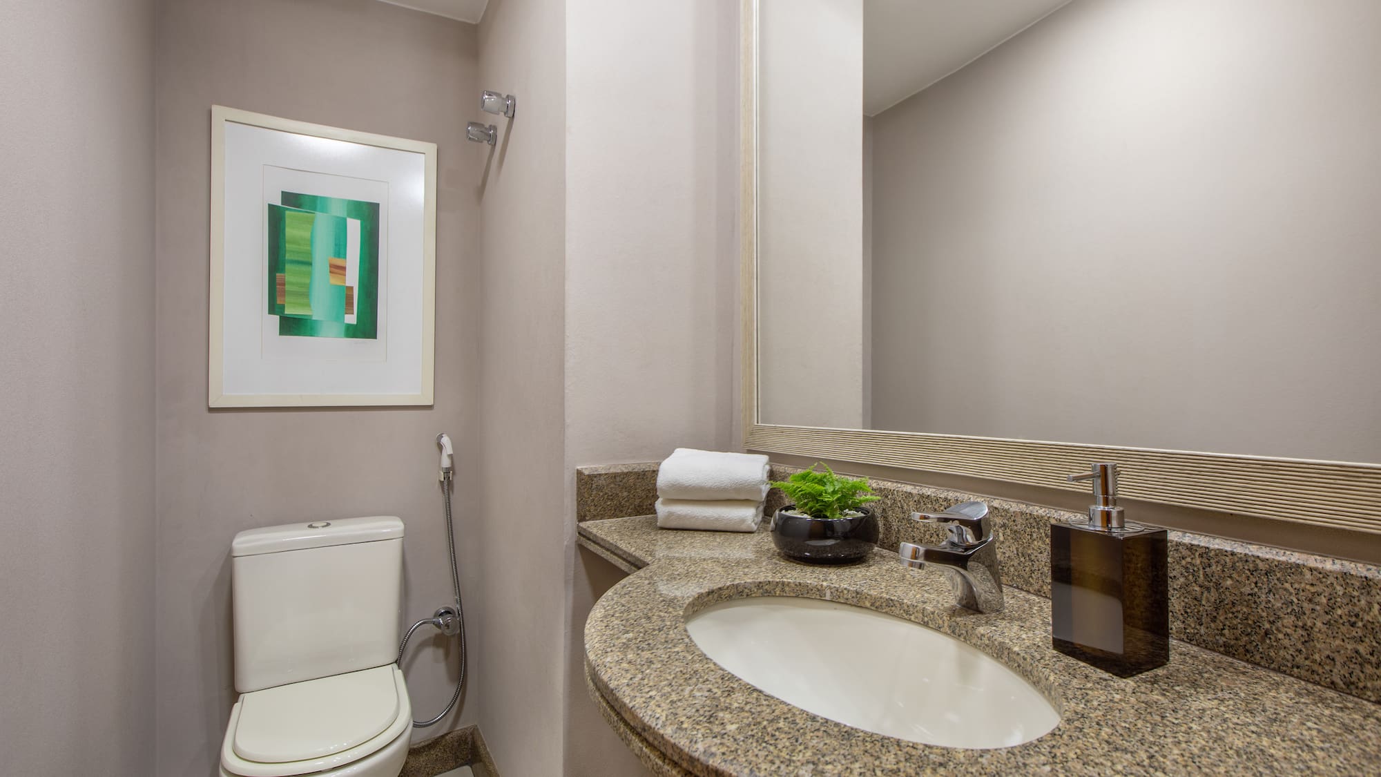 a bathroom with a marble countertop sink and a toilet