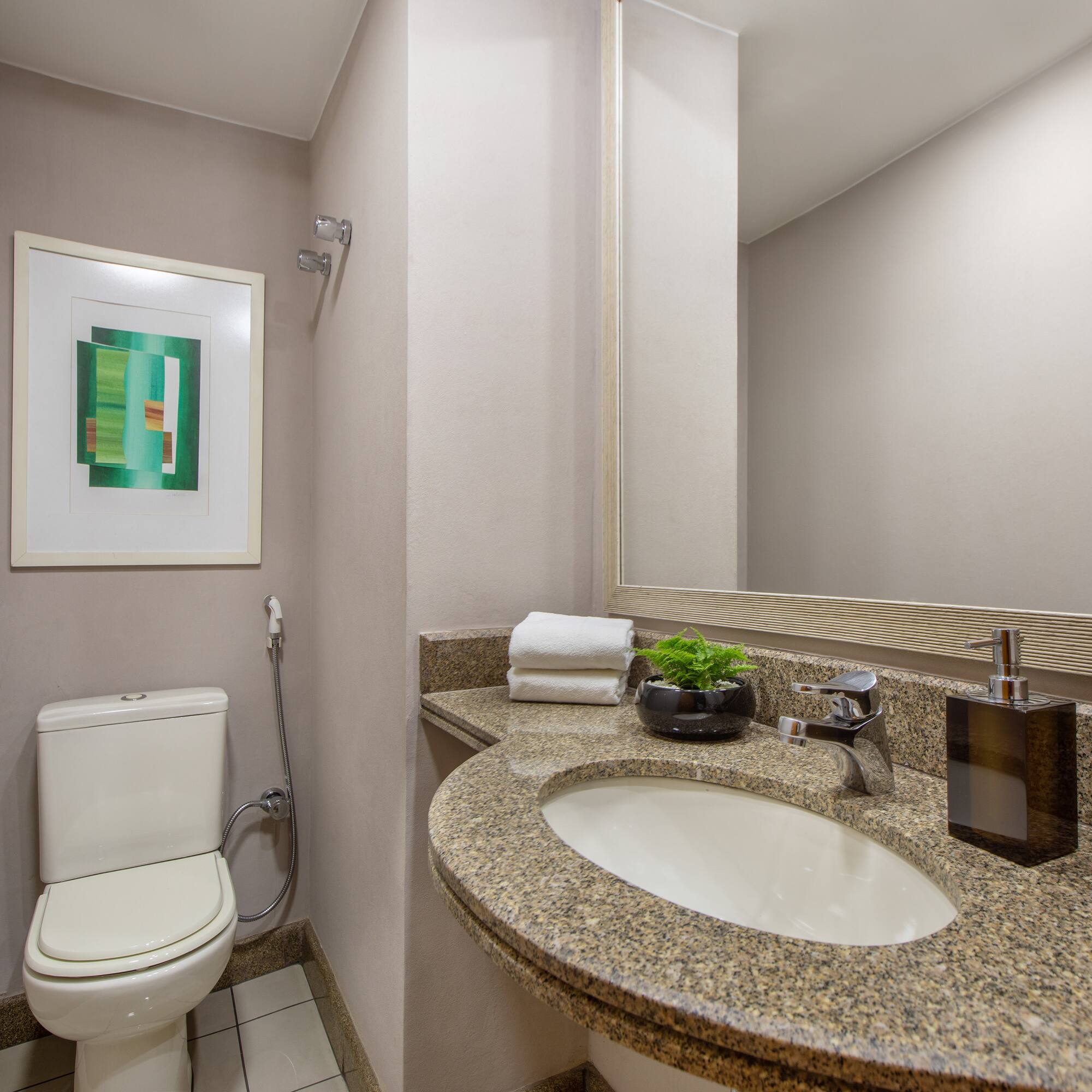 a bathroom with a marble countertop sink and a toilet