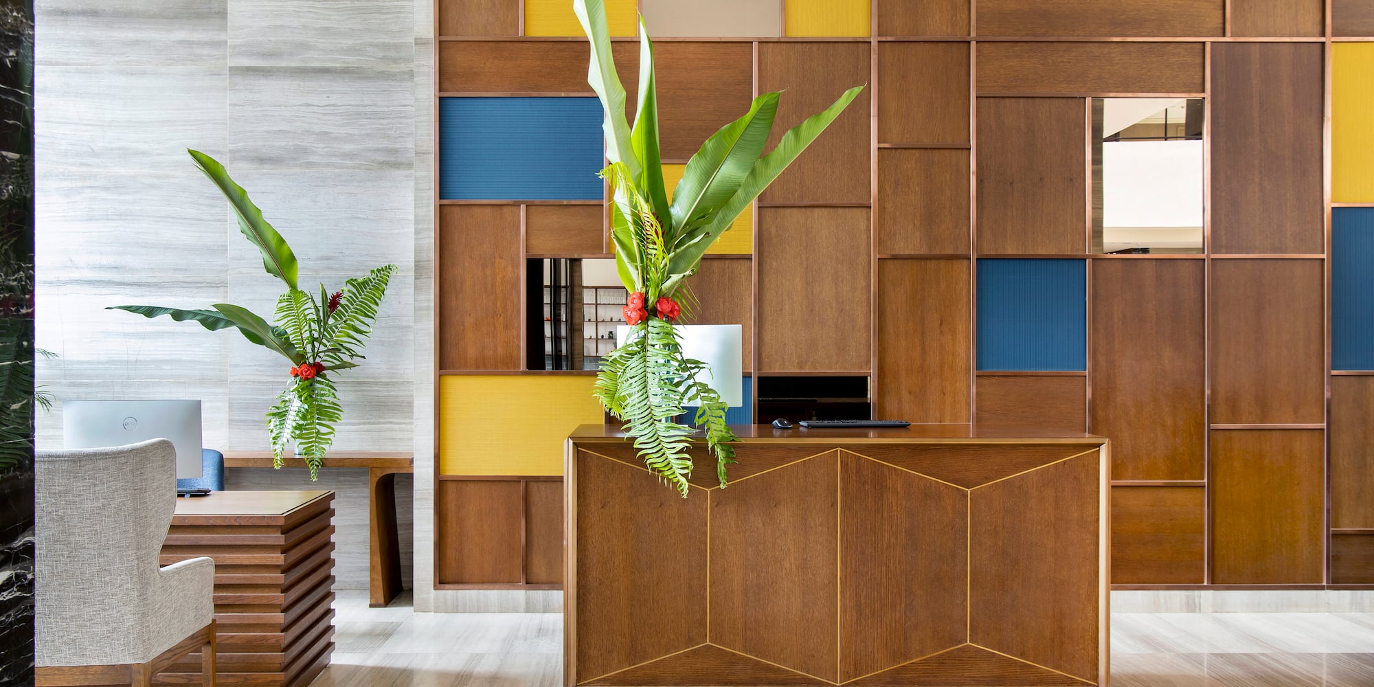 a room with a desk and plants