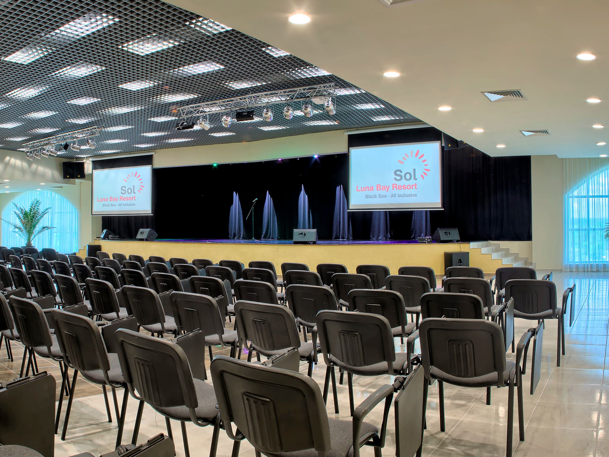 a room with chairs and a projector screen