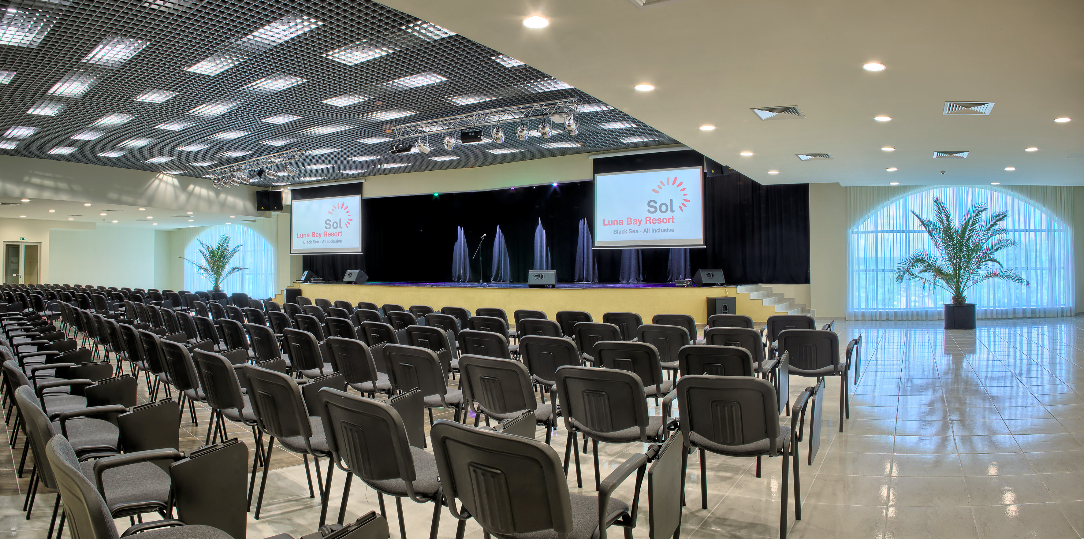 a room with chairs and a projector screen