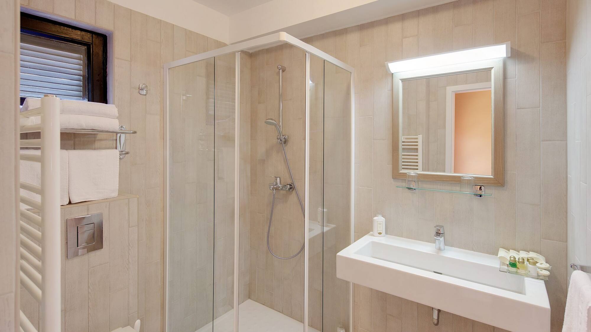 a bathroom with a glass shower and sink