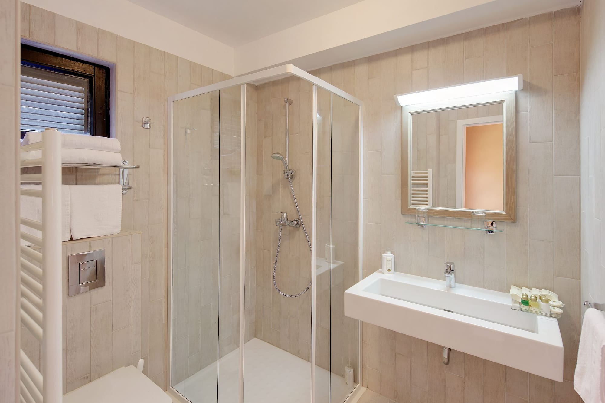 a bathroom with a glass shower and sink