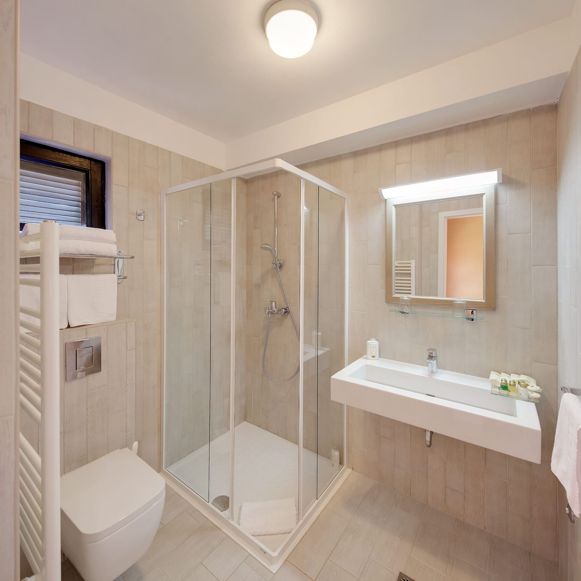 a bathroom with a glass shower and sink