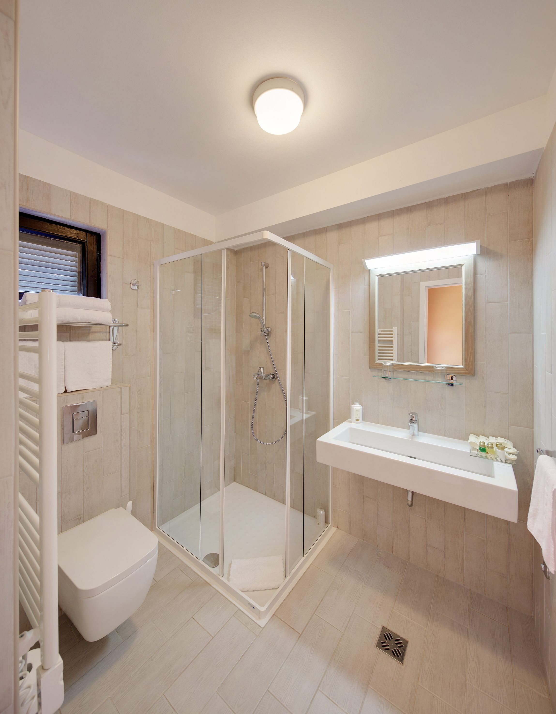 a bathroom with a glass shower and sink