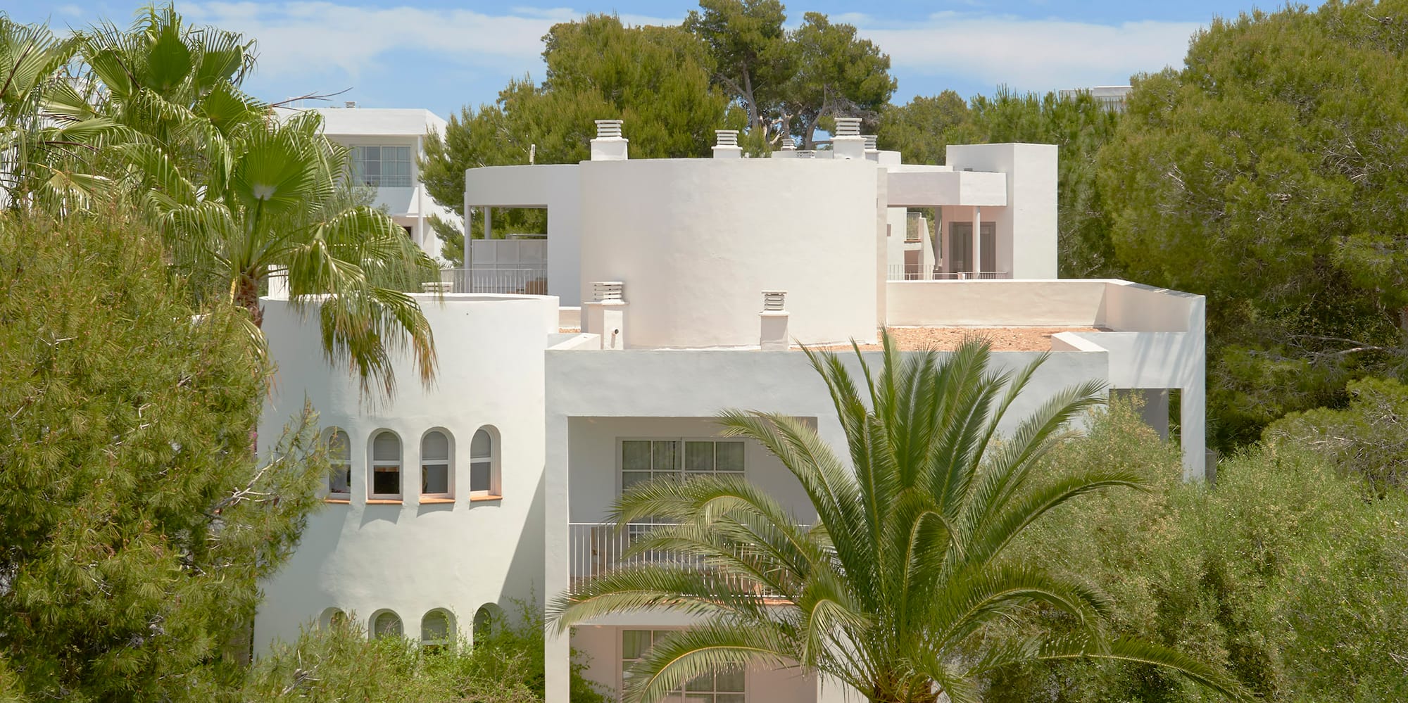 a white house with trees around it