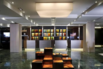 a lobby with a large counter and colorful shelves