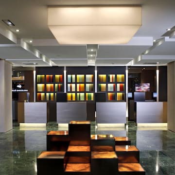 a lobby with a large counter and colorful shelves
