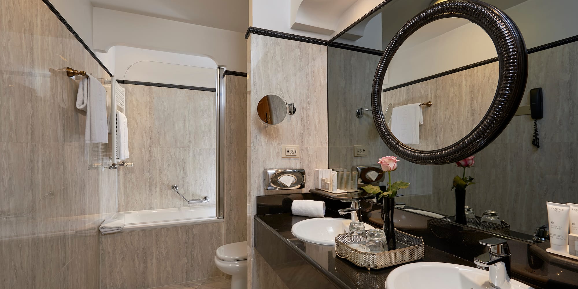 a bathroom with marble countertop and sink