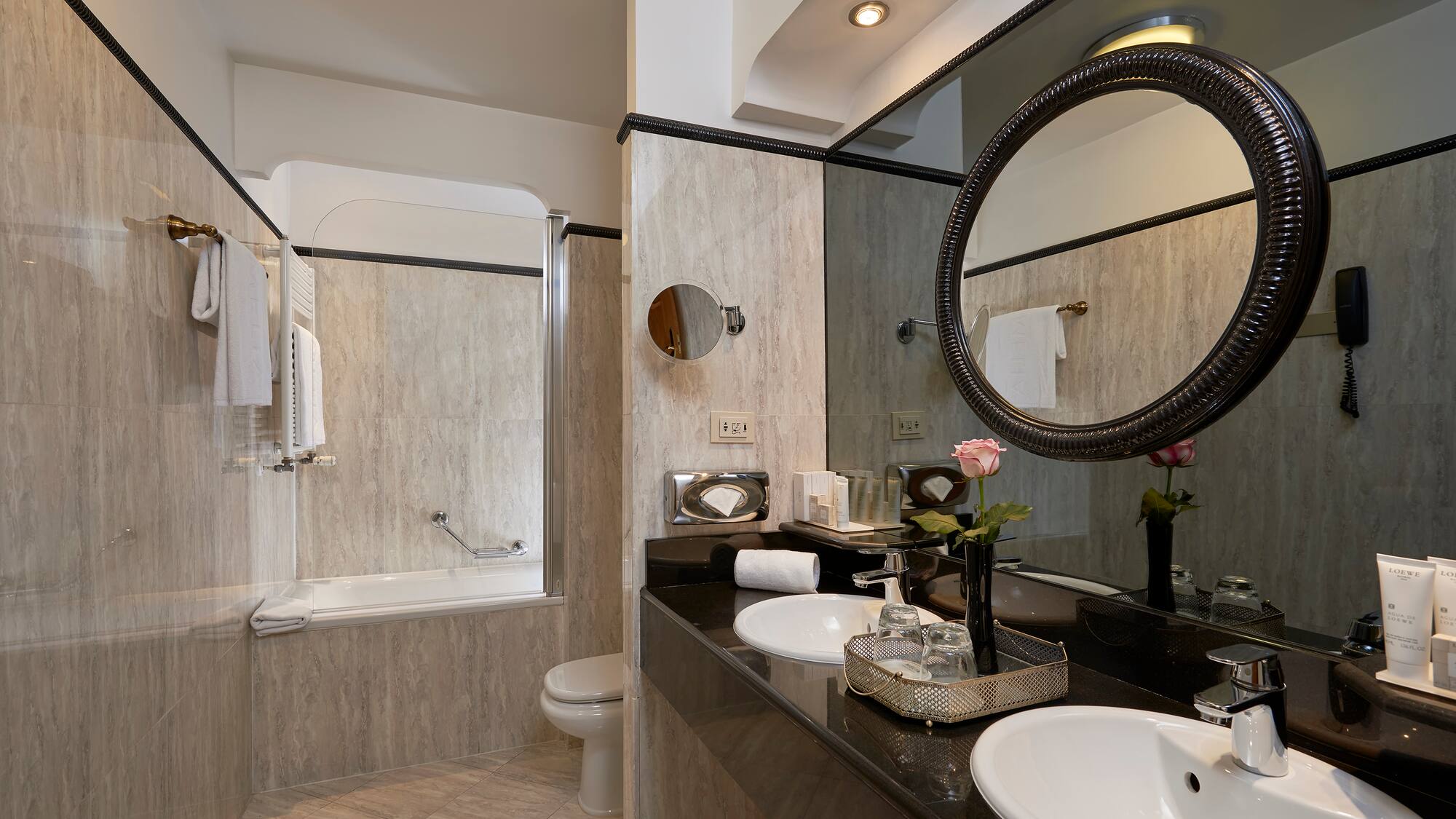 a bathroom with marble countertop and sink