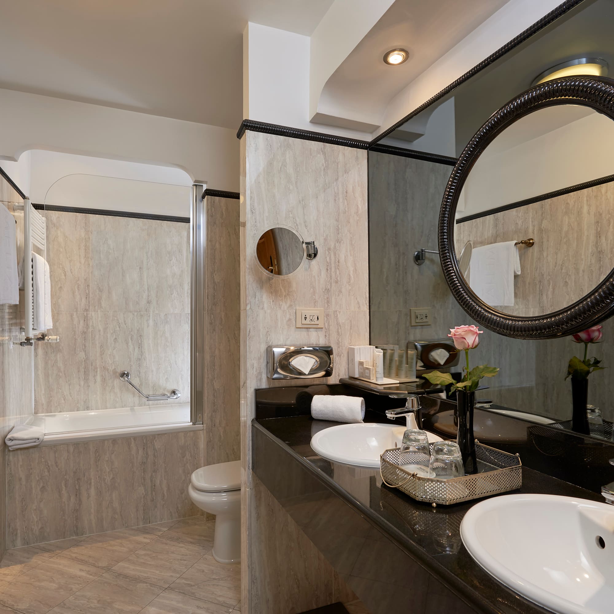 a bathroom with marble countertop and sink