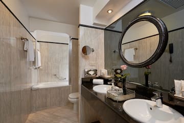 a bathroom with marble countertop and sink