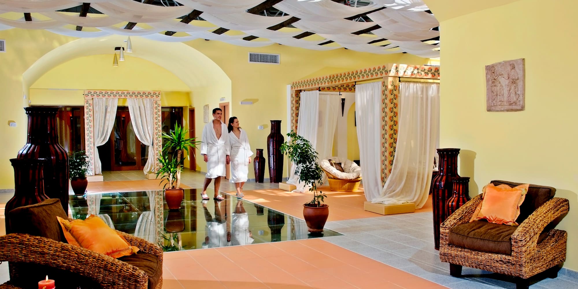 a couple in white robes in a room