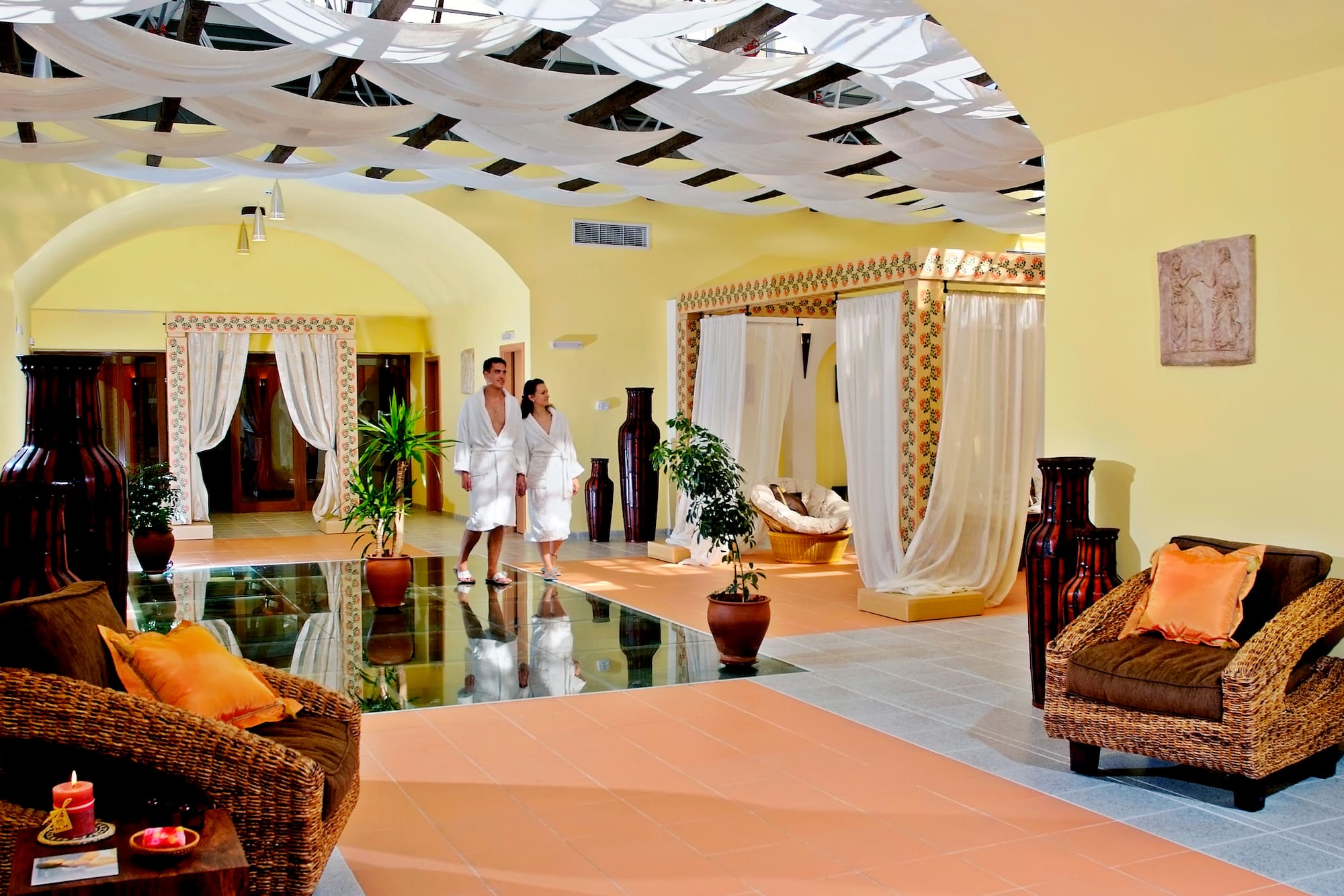 a couple in white robes in a room