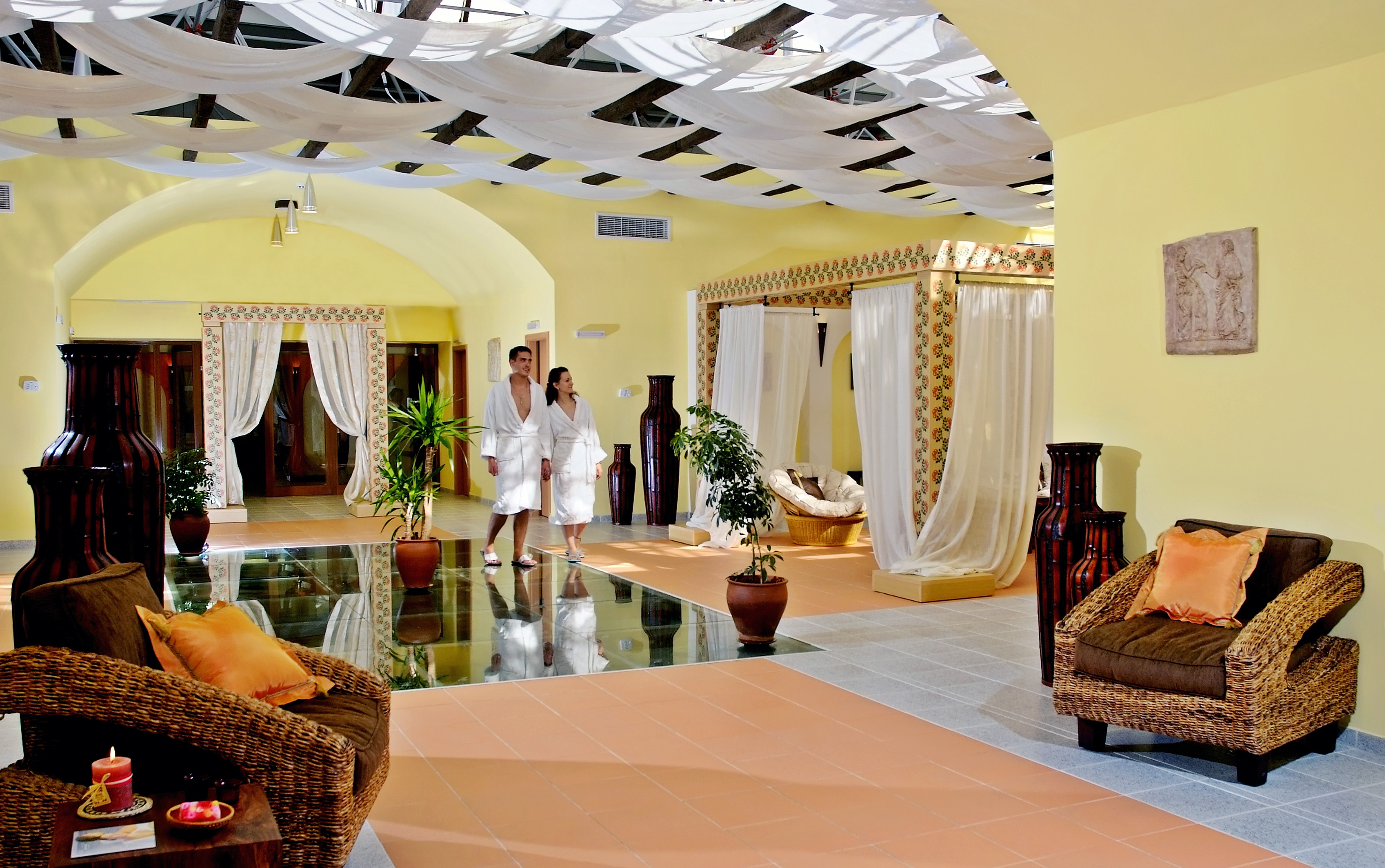 a couple in white robes in a room