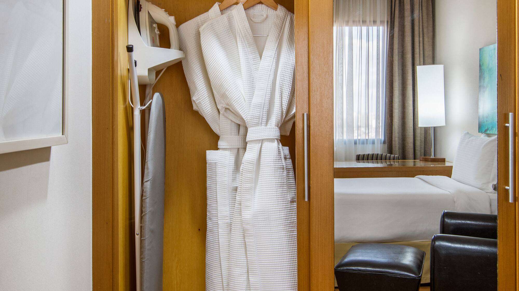 a closet with towels and a bathrobe