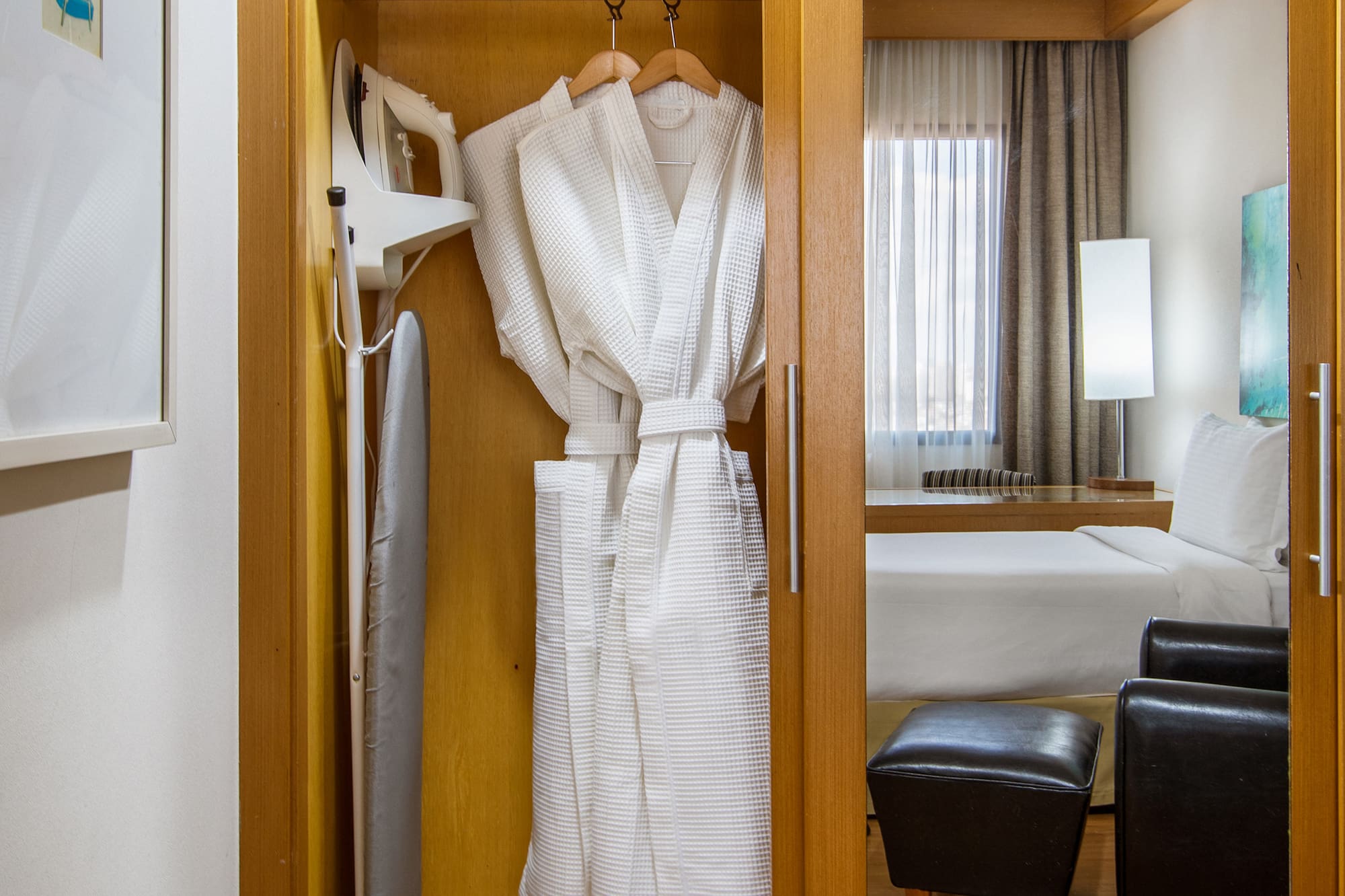 a closet with towels and a bathrobe