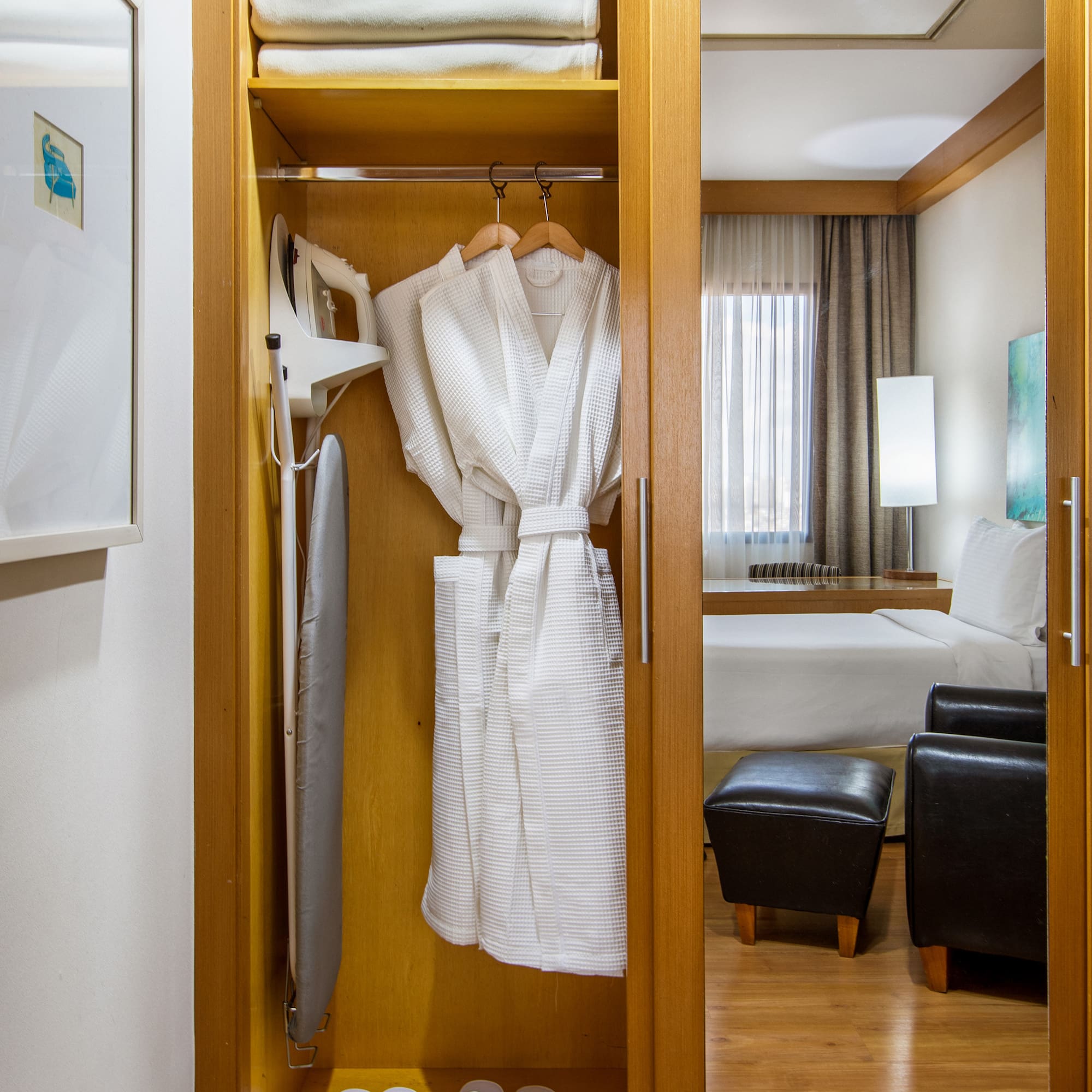 a closet with towels and a bathrobe