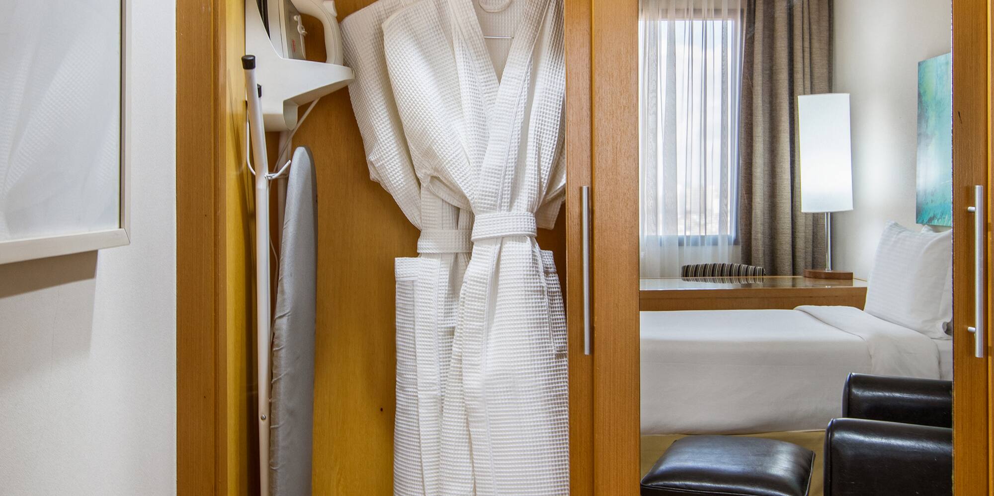 a closet with towels and a bathrobe