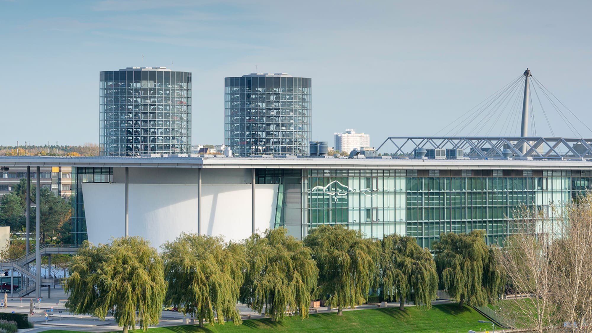 a building with glass windows and trees