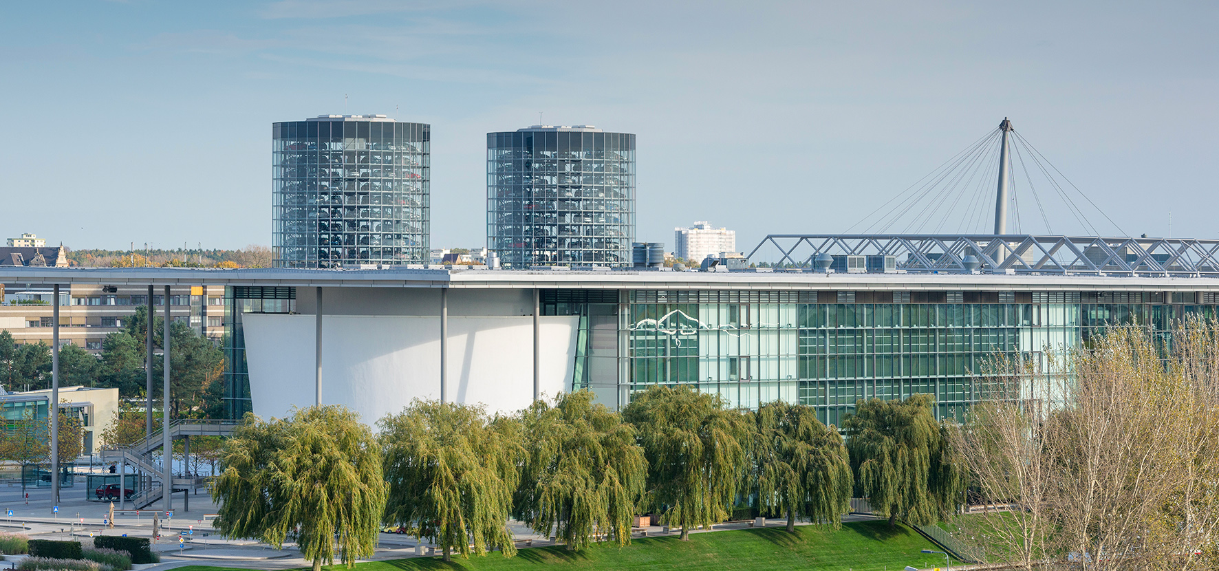 a building with glass windows and trees