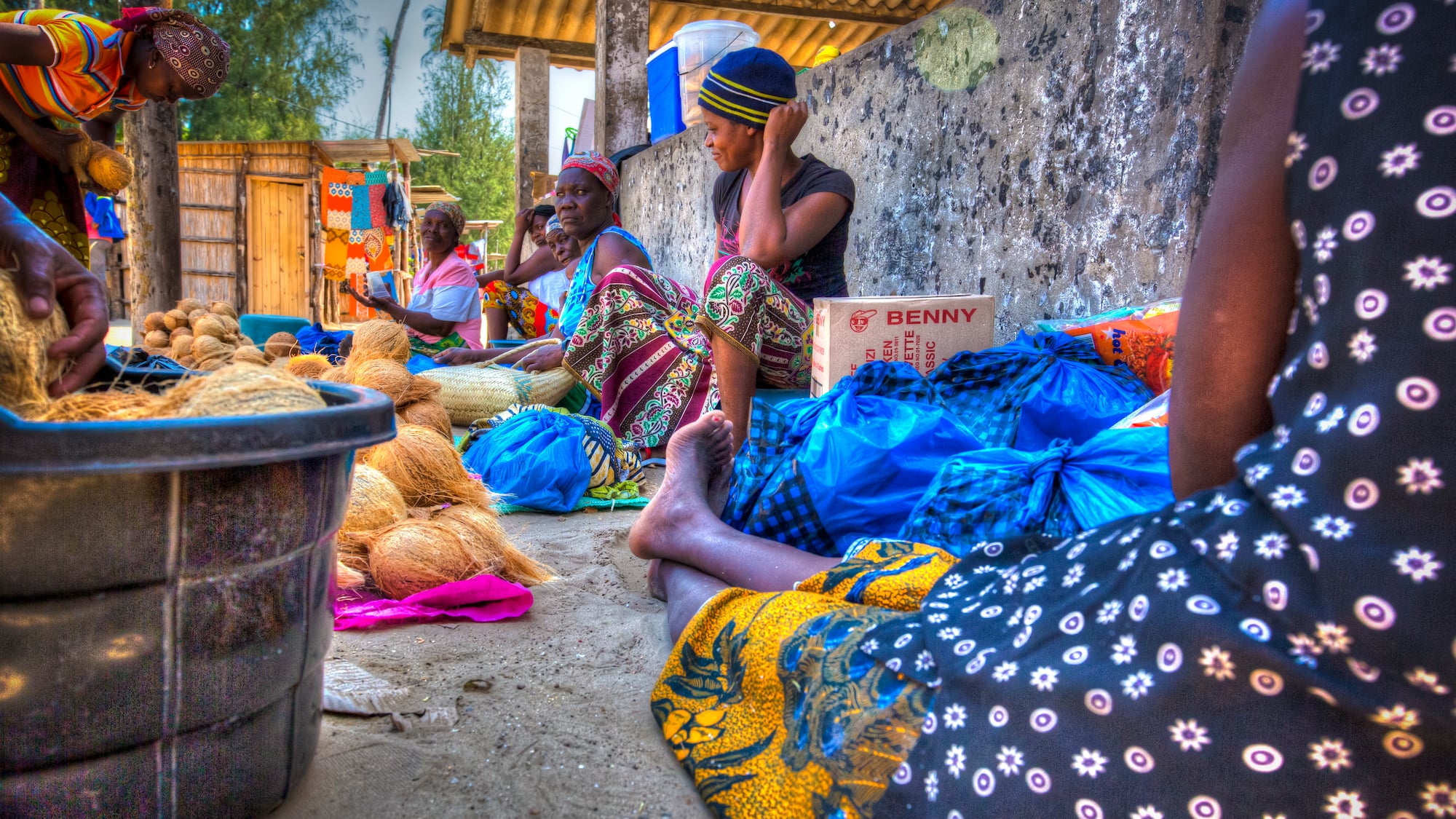 a group of women sitting on the ground