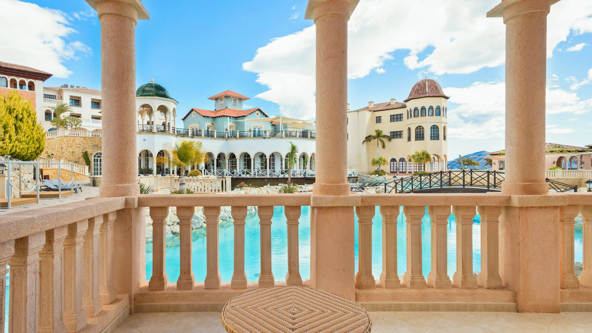 a balcony with a pool and a table