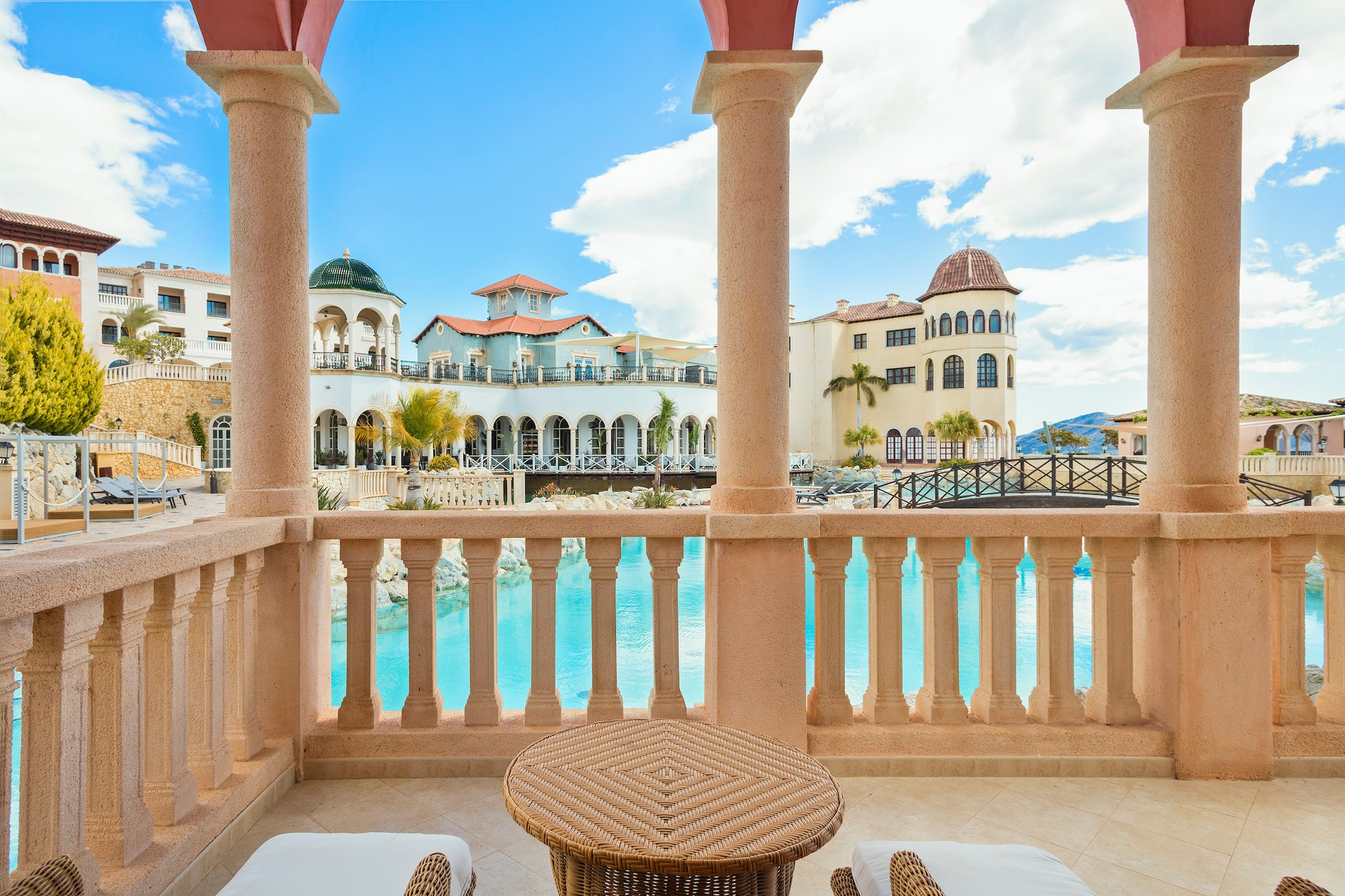 a balcony with a pool and a table