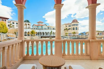 a balcony with a pool and a table