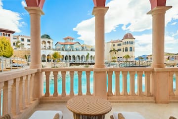 a balcony with a pool and a table