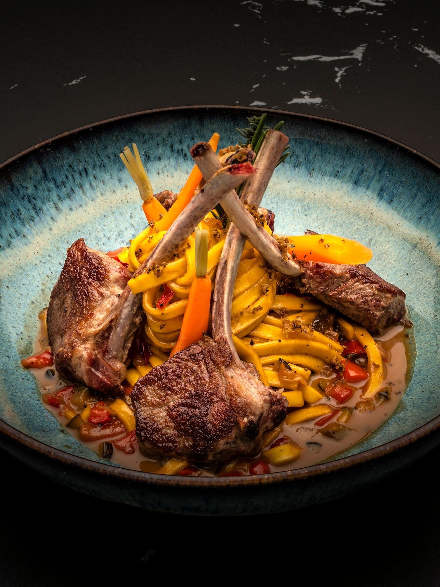 a bowl of food on a black surface